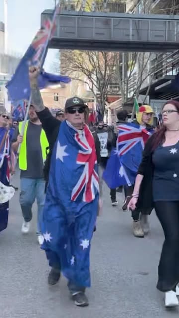 Large crowds have gathered in Sydney, waving Australian flag